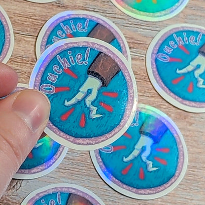 Ouchie! Dropped Pen Scout Badge-Holographic Waterproof Vinyl Sticker